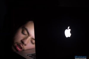 Man asleep at computer at night