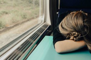 woman sleeping on train