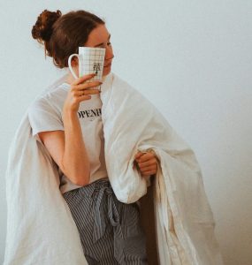 woman with cup against head